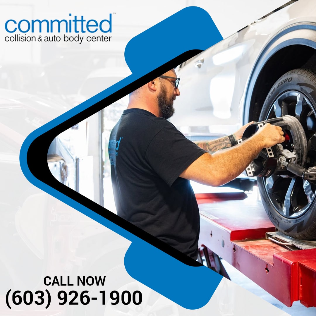 Can a Collision Damage Your Car's Battery and Electrical System? 2 An auto body technician in glasses mounting a precision wheel alignment clamp onto a car tire resting on a red lift bay.